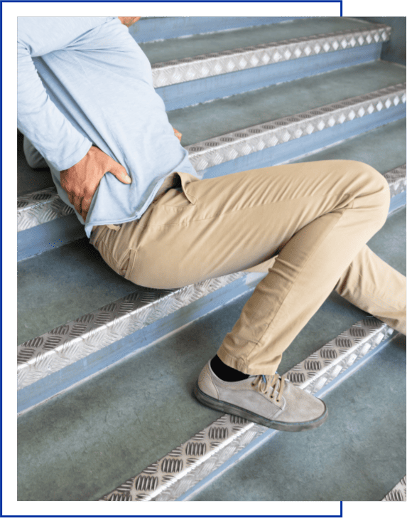 Man Lying On Staircase After Slip And Fall Accident