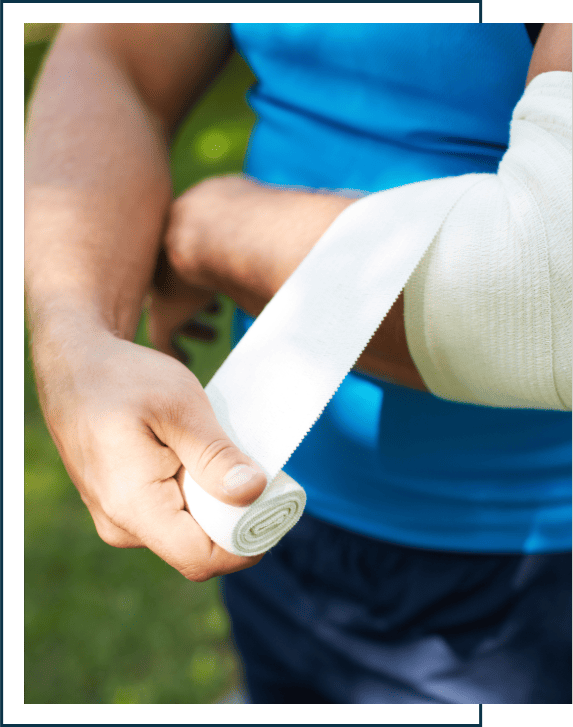 Close-up of male bandaging his arm